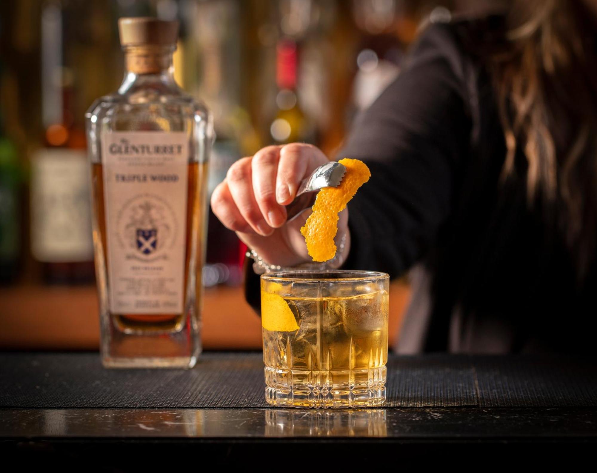 Schloss Roxburghe, Part Of Destination By Hyatt מראה חיצוני תמונה A bartender adding a lemon twist to a glass of GINfinity