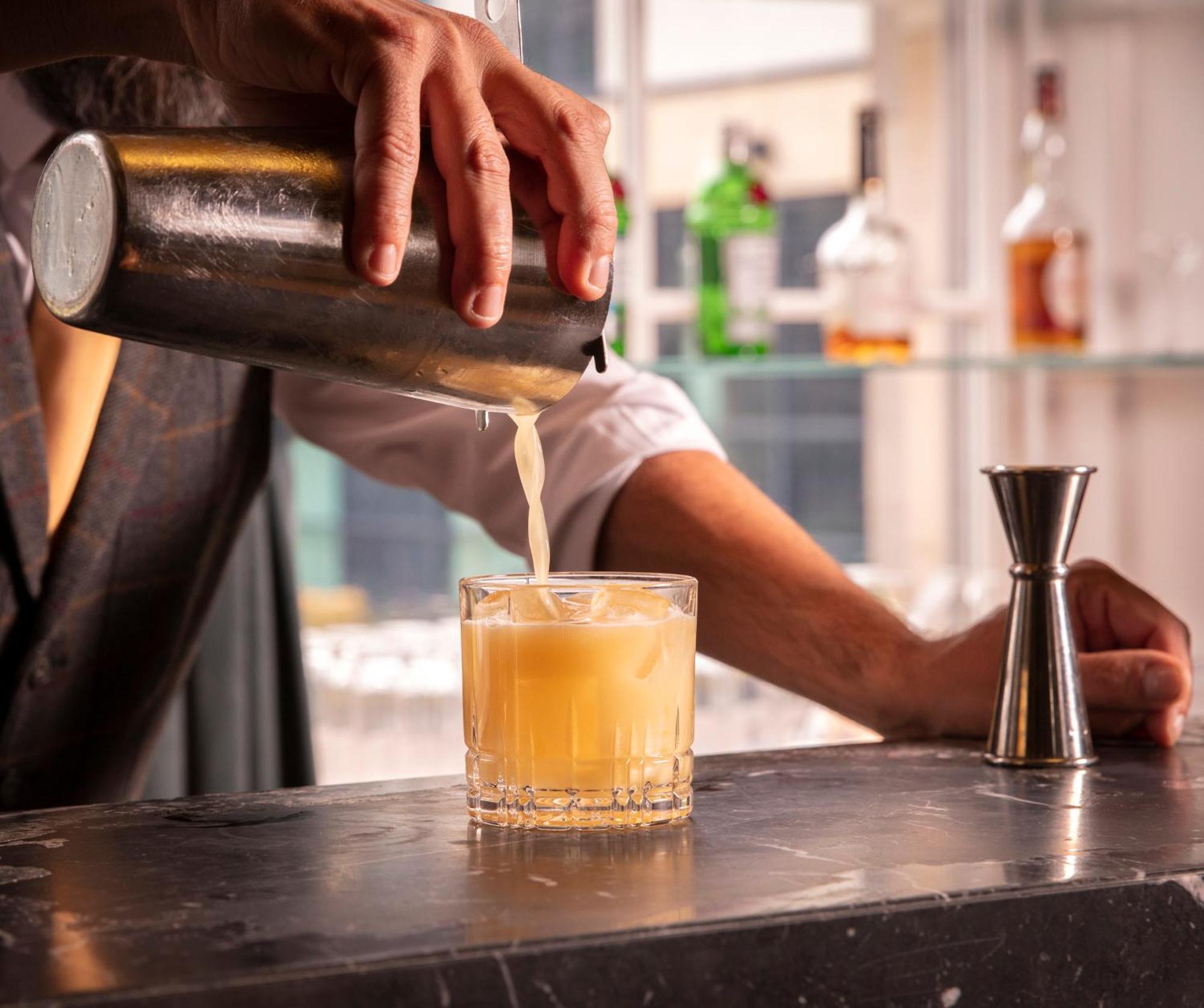 Schloss Roxburghe, Part Of Destination By Hyatt מראה חיצוני תמונה A bartender straining a cocktail
